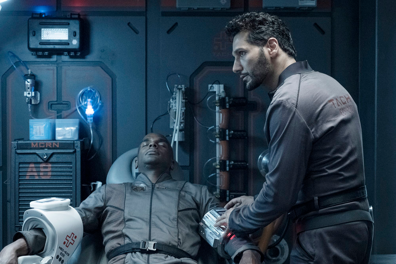 Alex (Cas Anvar) tends to a wounded Martian.